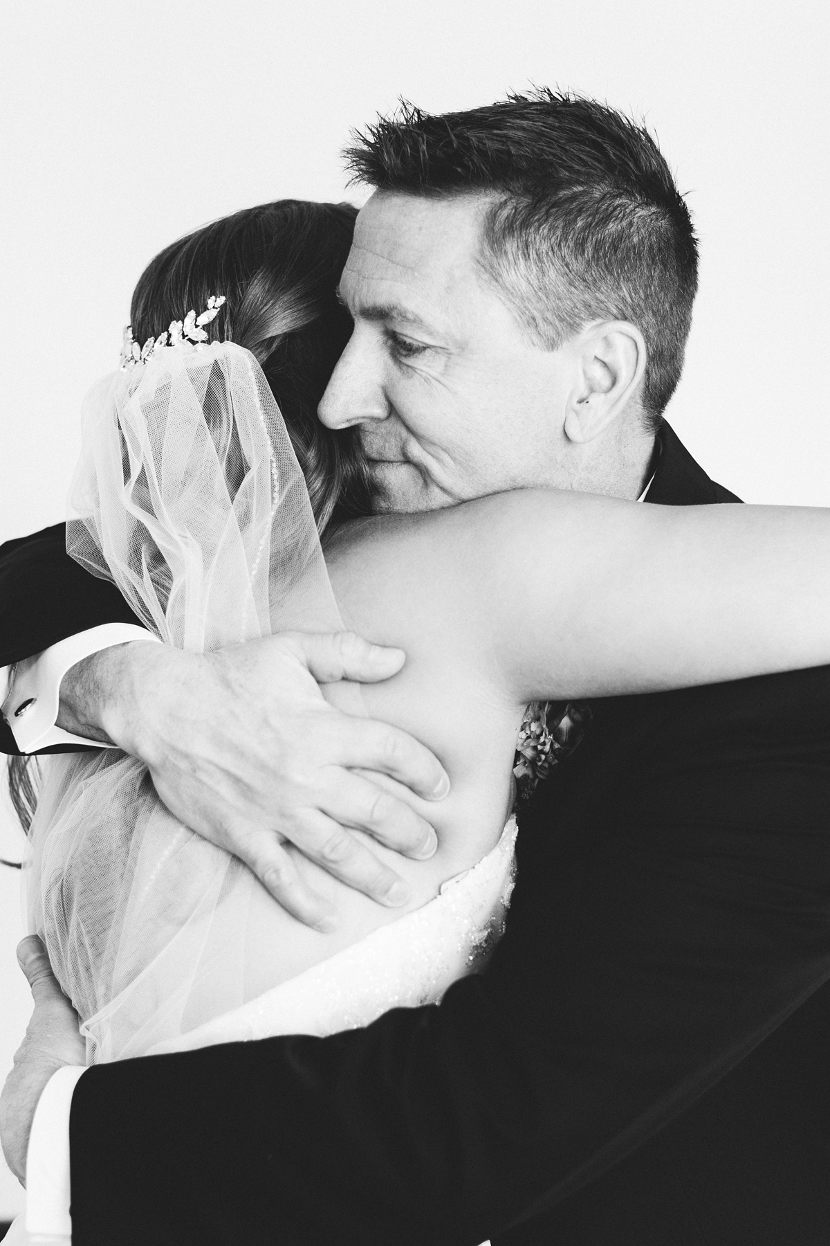 Gathering Barn Williamsburg Iowa Wedding bride and father embracing before wedding