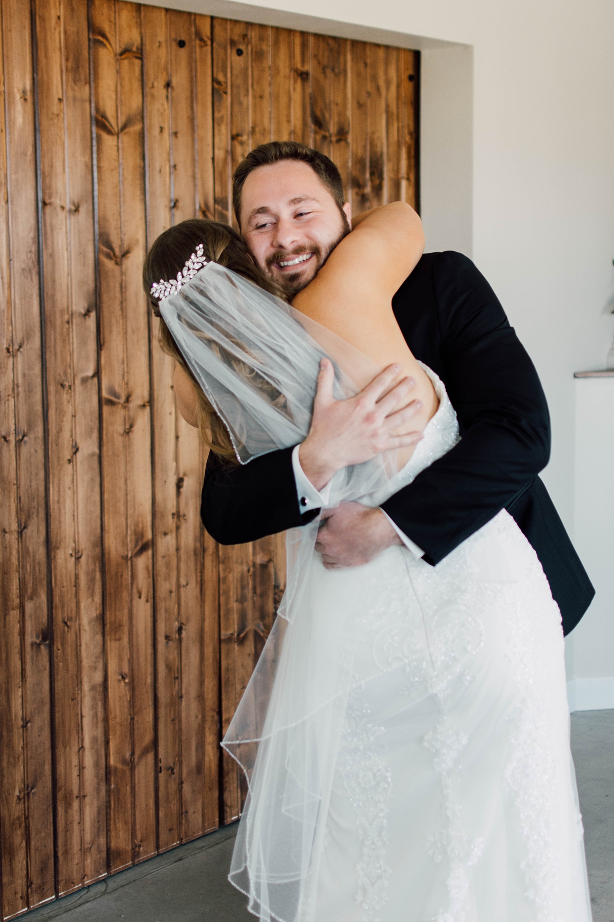 Gathering Barn Williamsburg Iowa Wedding bride and groom embracing during first look