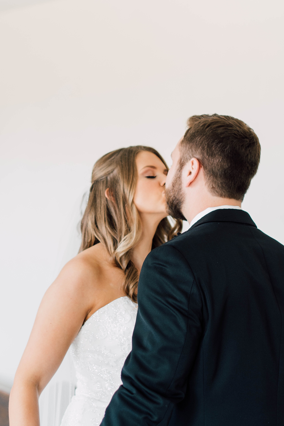 Gathering Barn Williamsburg Iowa Wedding bride and groom kissing before ceremony