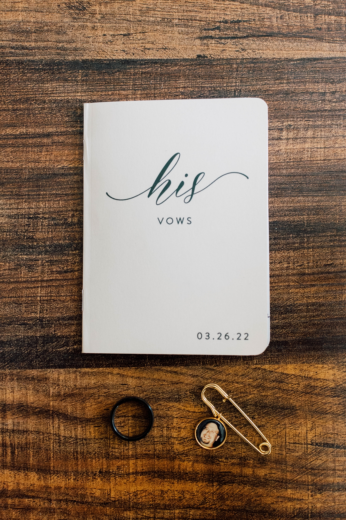 Gathering Barn Williamsburg Iowa Wedding vow book with groom's flat lay details