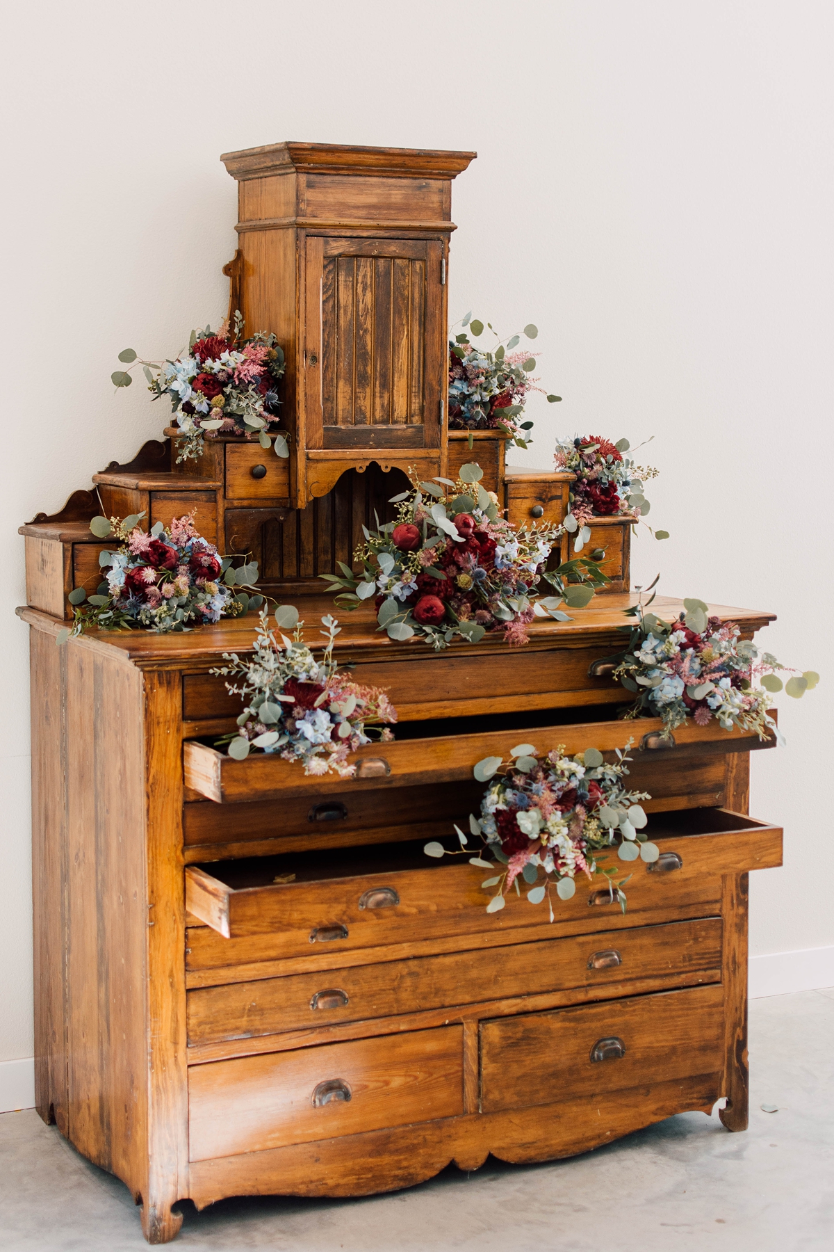 Gathering Barn Williamsburg Iowa Wedding bridal bouquets displayed on antique dresser