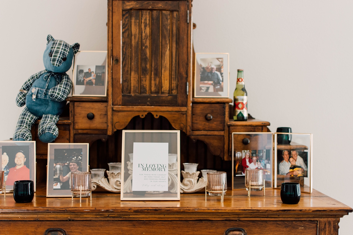 Gathering Barn Williamsburg Iowa Wedding table of family photos at reception