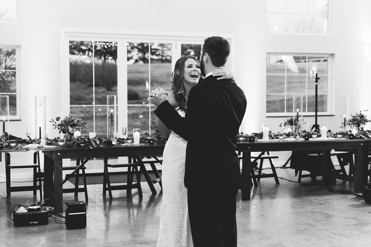 Gathering Barn Williamsburg Iowa Wedding bride and groom laughing while dancing at reception