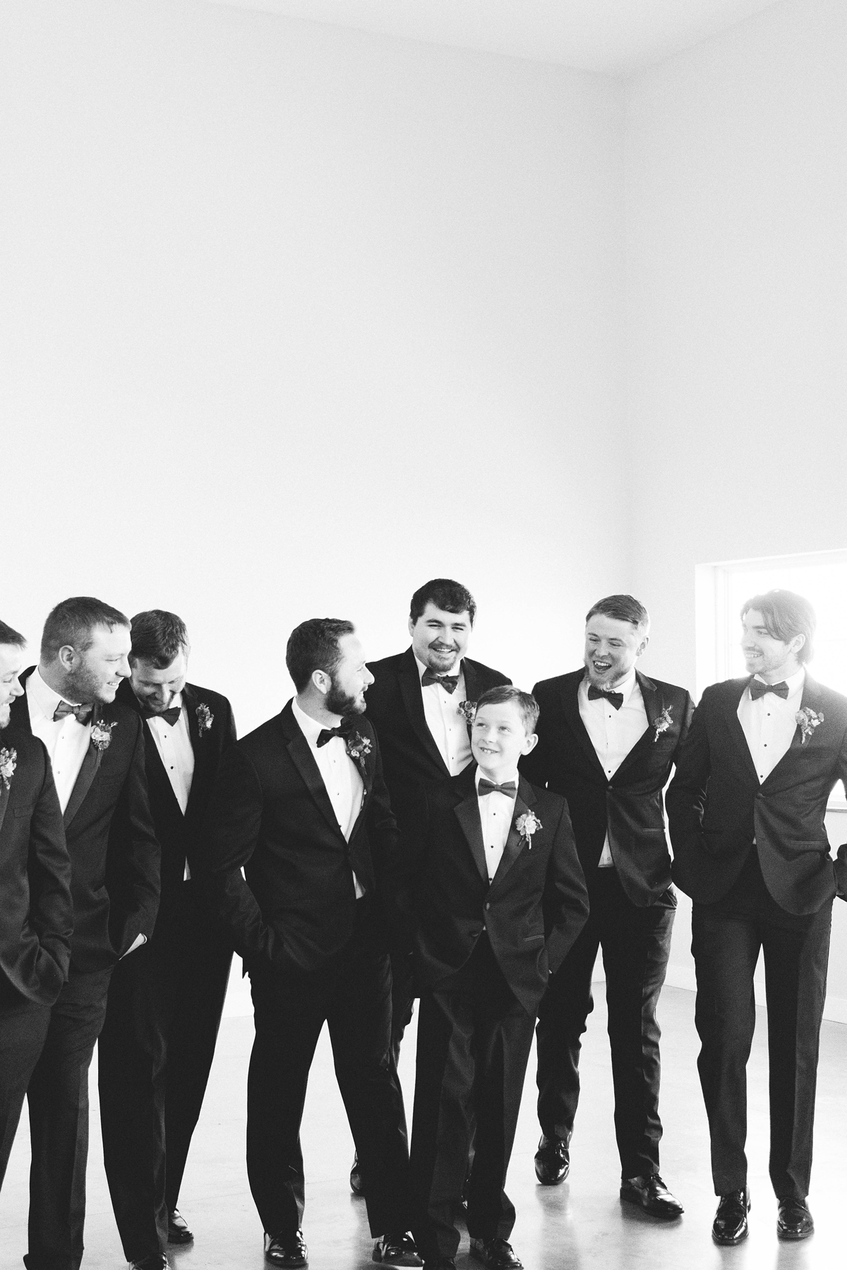 Gathering Barn Williamsburg Iowa Wedding groomsmen in black tuxes