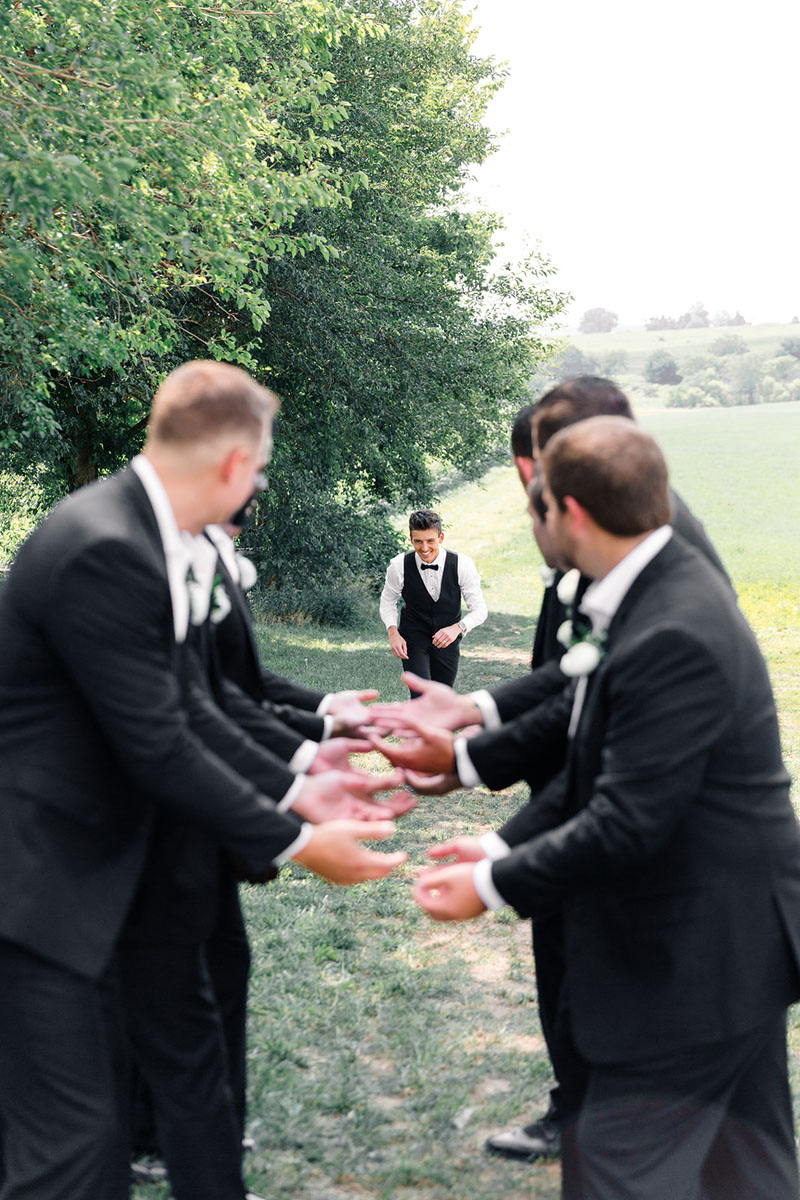 groom running towards groomsmen walker homestead