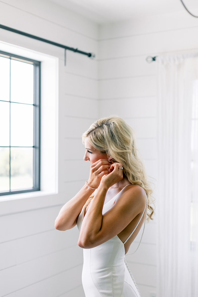 bride putting on earring at walker homestead