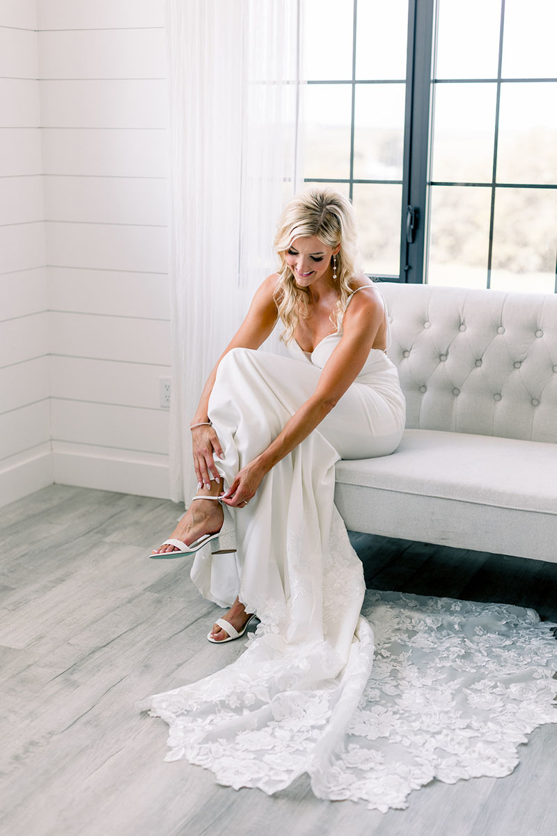 bride putting on shoes at walker homestead with borrow my vintage couch