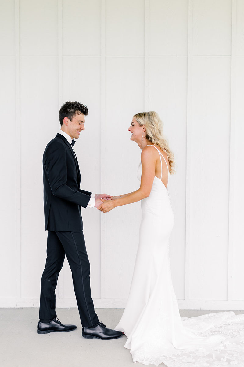 bride and groom first look giggles