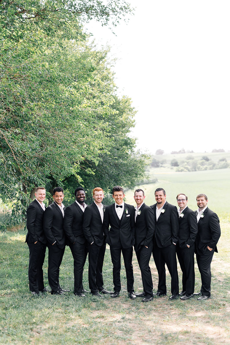 all smiles for the groomsmen in black tuxes
