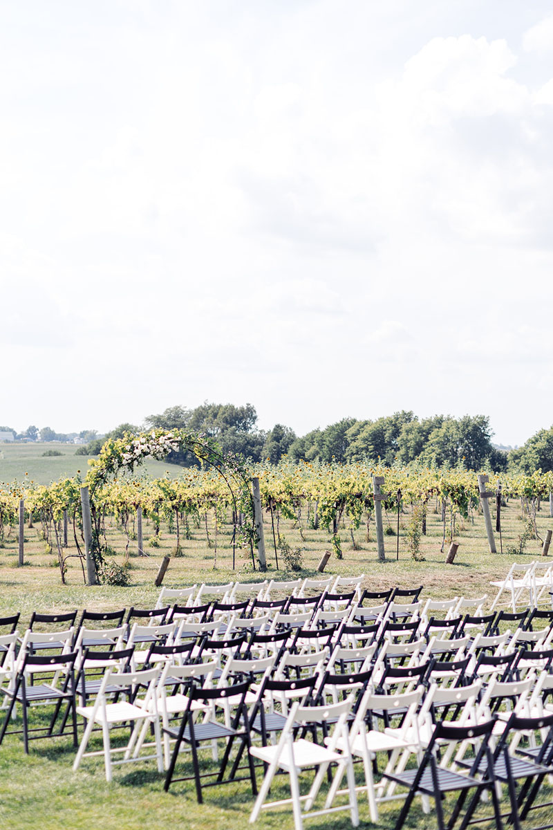 white and black chairs by the floral arbor arch at walker homestead