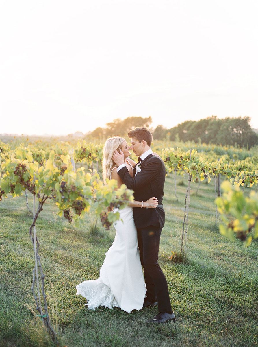 bride and groom embracing in vineyard walker homestead